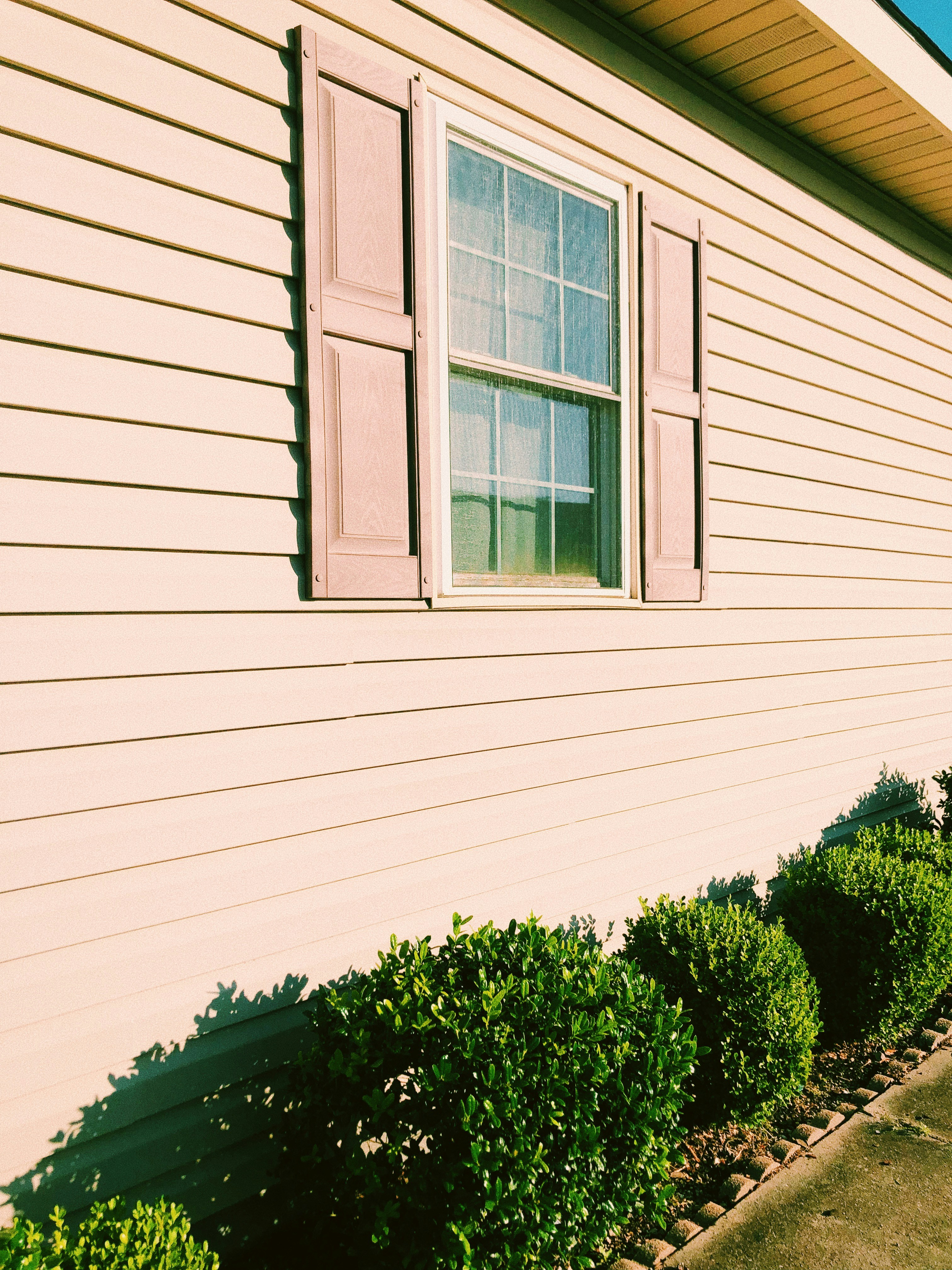 Vinyl siding with shutters and window on a Virginia home