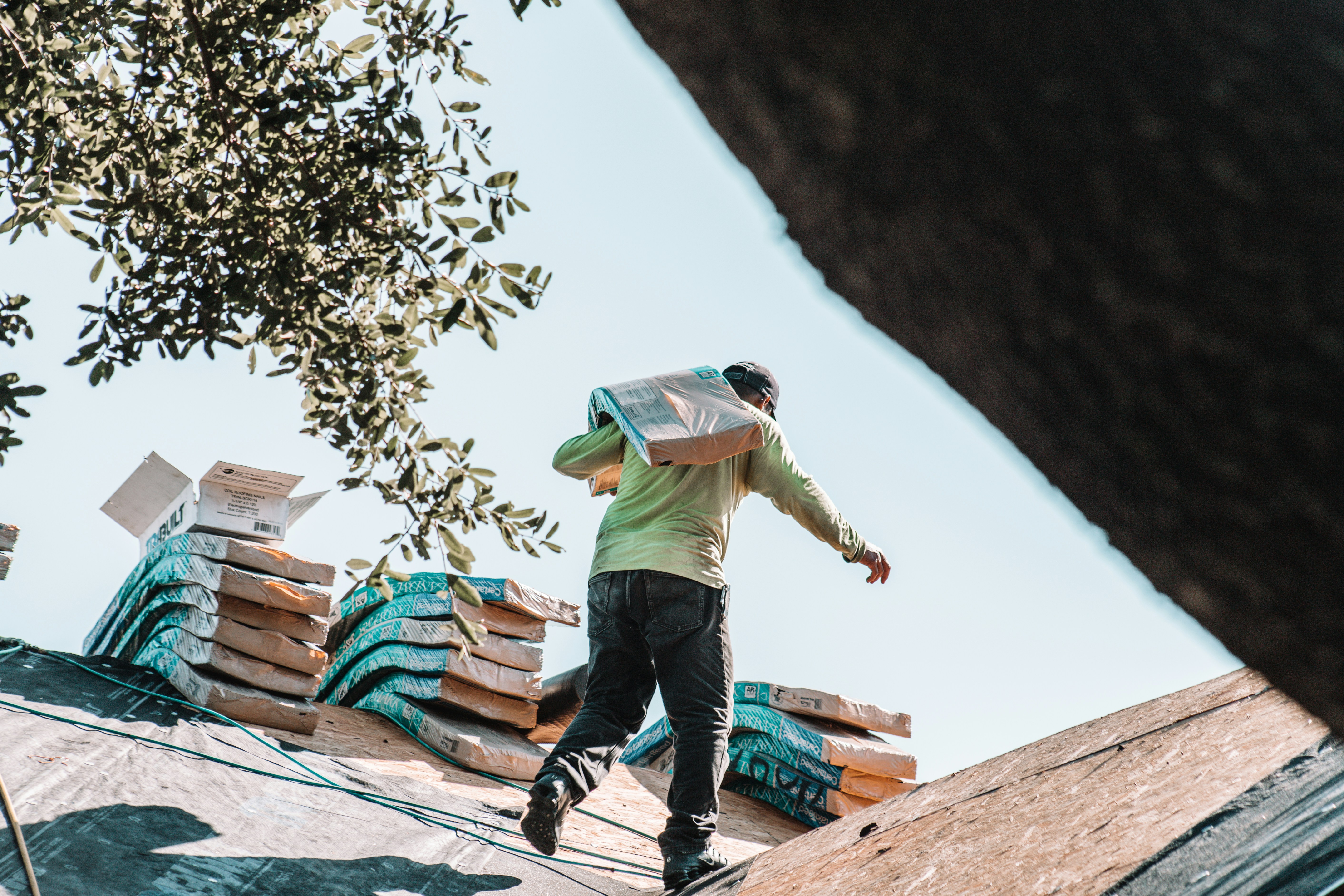 Roofer carrying shingle bundles — Verona, VA